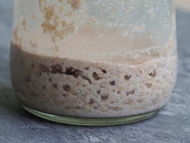 Toptan un ile pişirilmiş canlı ekşi ekmek yakın plan.
