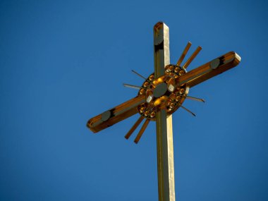 Golden cross of orthodox church on blue sky background