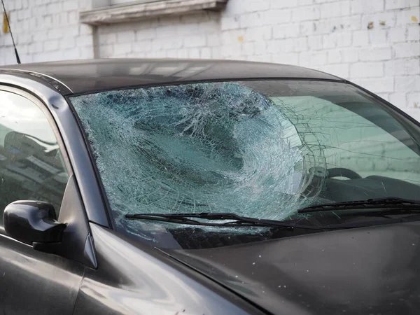 Car after a road accident with a cracked windshield