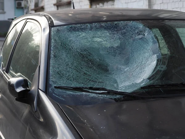 Car after a road accident with a cracked windshield