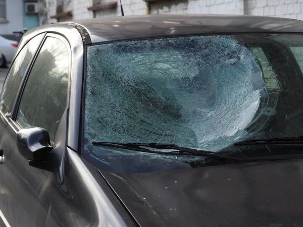 Car after a road accident with a cracked windshield