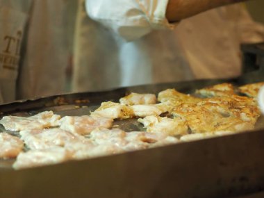 Bir restoranda büyük bir tavada çırpılmış yumurta pişirmek.