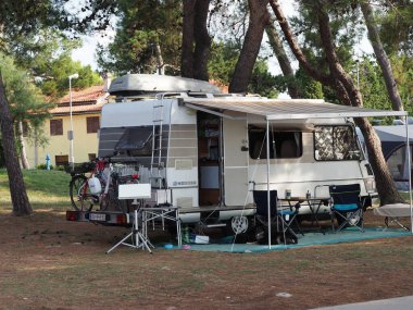 Motor home in a camping in a pine forest