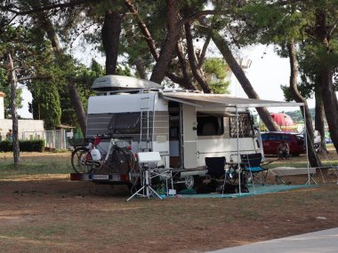 Motor home in a camping in a pine forest