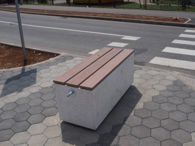 A park bench made of wooden boards and concrete