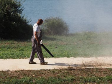 Cleaning up mowed grass on the lawn