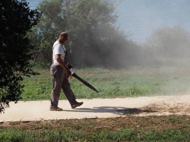 Cleaning up mowed grass on the lawn