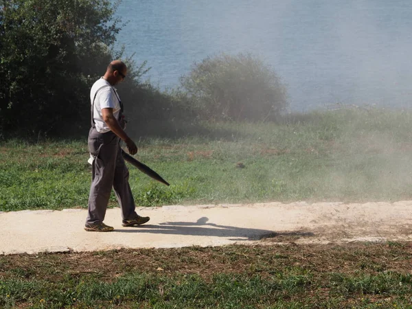 Cleaning up mowed grass on the lawn