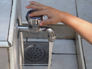 Close-up of a small water faucet for washing hands at a campsite on the seashore