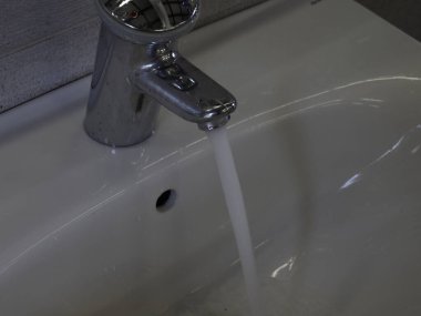 An open water tap from which water flows