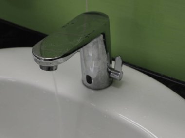 An open water tap from which water flows