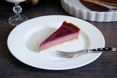 Beyaz tabakta bir parça böğürtlenli turta