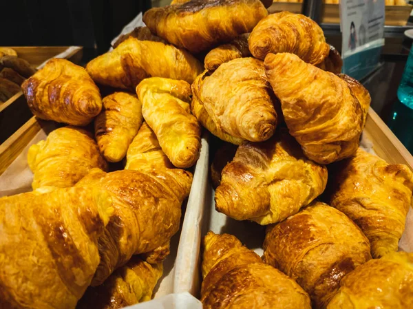 Close-up of croissants in old wooden boxes — Stock Photo, Image