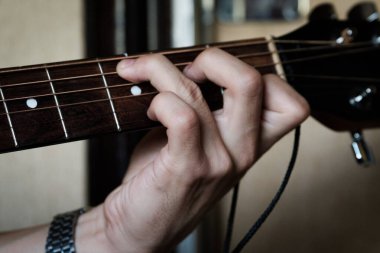 El gitar üzerinde ustaca çalıyor..