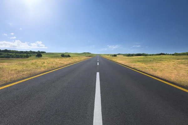 Driving on an empty road at bright sunny day — Stock Photo, Image