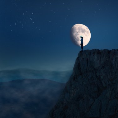 Lonely young woman on top of a cliff at night clipart