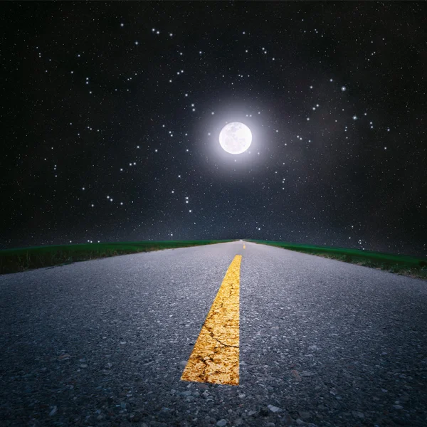 Driving on an empty road by moonlight — Stock Photo, Image