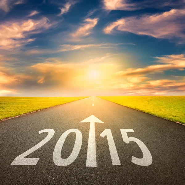 Driving on an empty road at sunset forward to 2015 — Stock Photo, Image