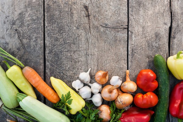 Fresh vegetables on vintage wooden background