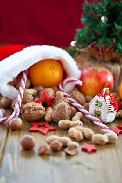 Christmas stocking filled with fruit and nuts — Stock Photo, Image
