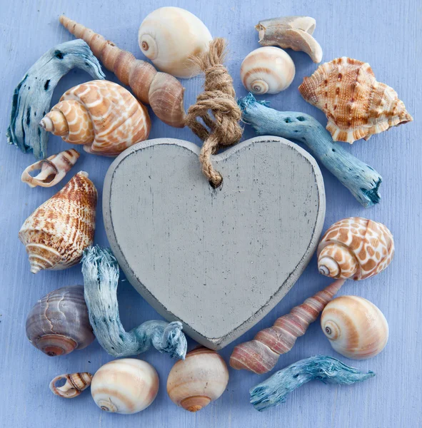 与海贝壳和心木制背景 — 图库照片
