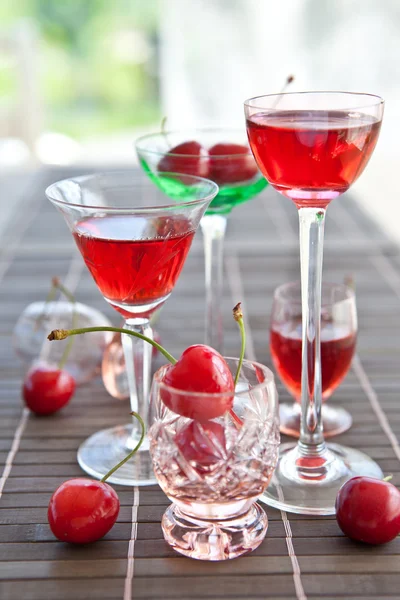 Various little glasses with cherry liquor — Stock Photo, Image