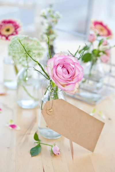 Fresh flowers in little bottles — Stock Photo, Image