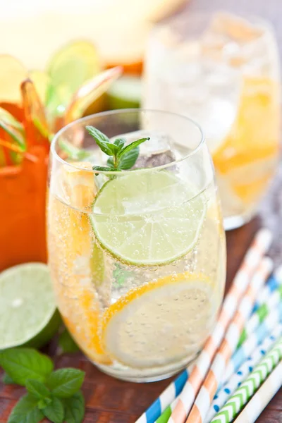 Cold drink with lemons and oranges — Stock Photo, Image