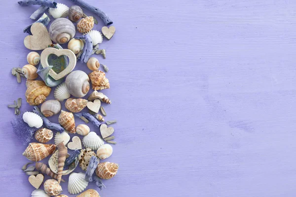 Fondo de madera con conchas marinas y corazones — Foto de Stock