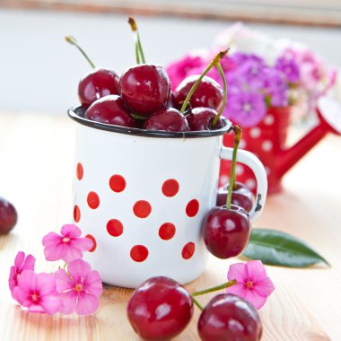 Vintage cup with fresh cherries clipart
