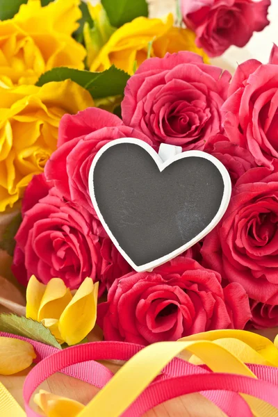 Colorful roses and a little blackboard — Stock Photo, Image