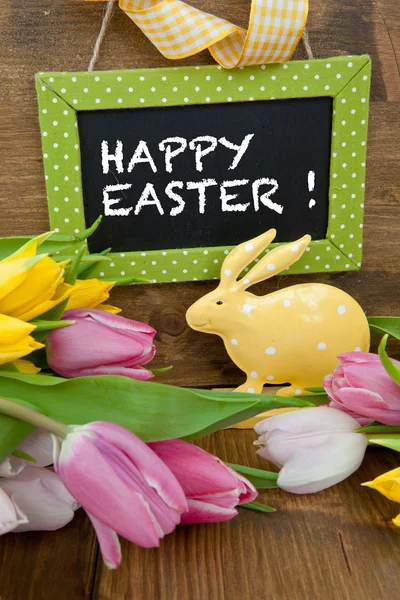 Little easter bunny and colorful tulips — Stock Photo, Image