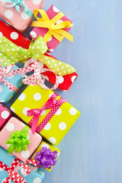 Colorful gift boxes wrapped in dotted paper — Stock Photo, Image