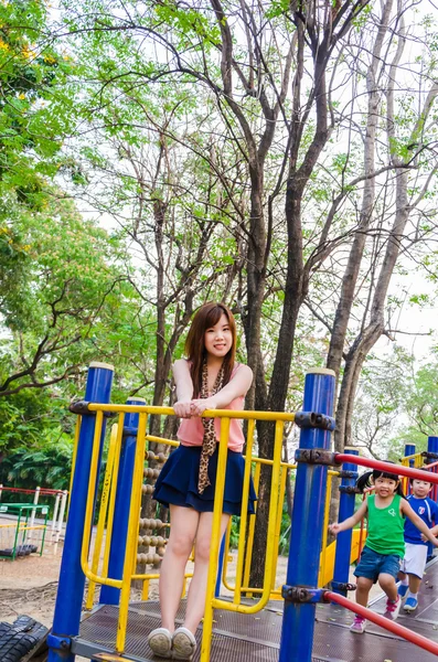 Thai girl playing children's playgroun — Stock Photo, Image