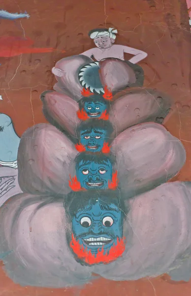 La pintura mural de un excusador rebanando cabezas de gente pecadora — Foto de Stock