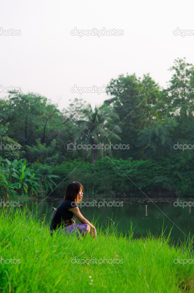 Cute Thai girl is letting her mind flow across the river bank