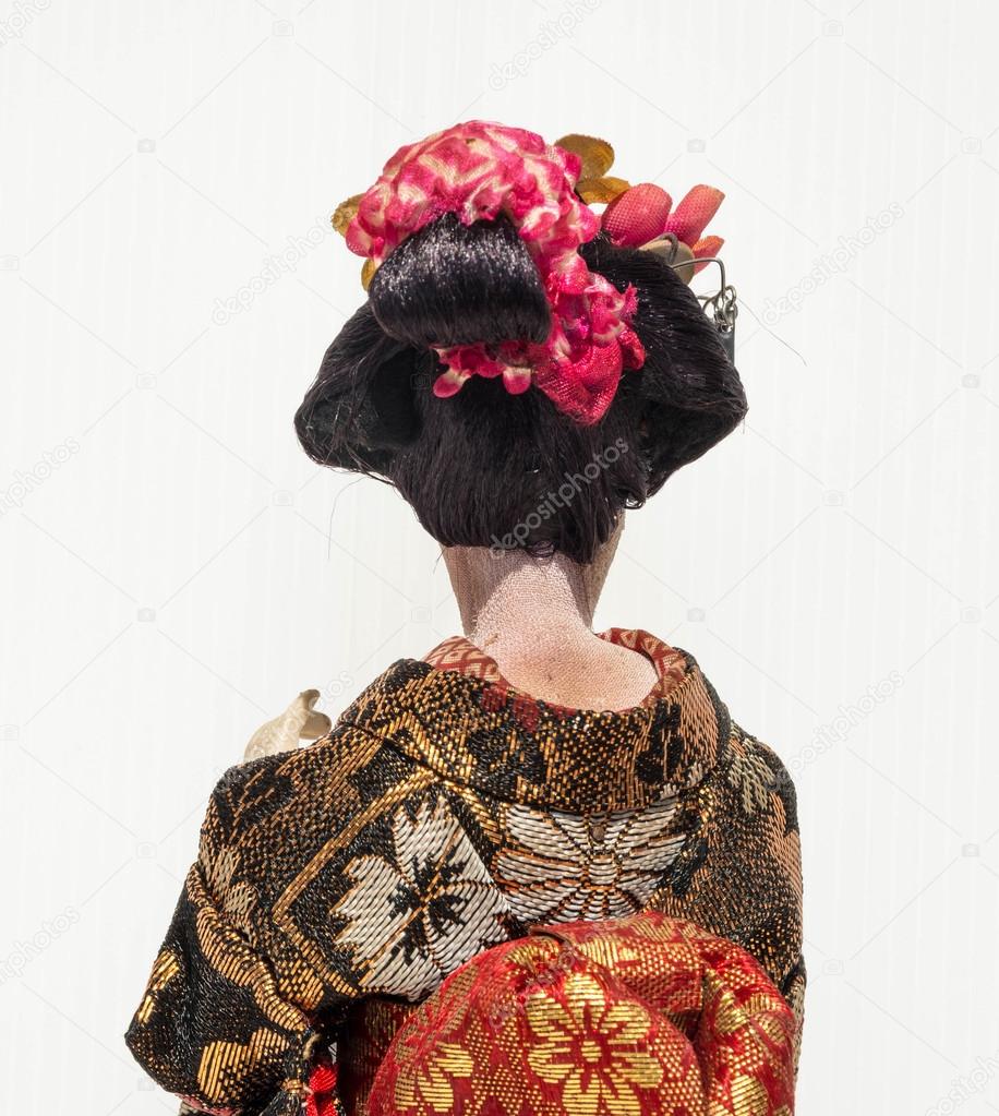 Backside of Japanese traditional doll of dancing Geisha with whi