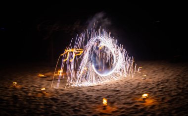 Fire show on the beach at night in Phuket, Thailand