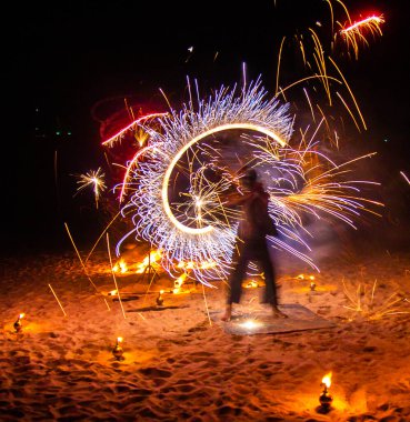 Fire show on the beach at night in Phuket, Thailand