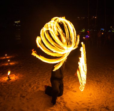 Fire show on the beach at night in Phuket, Thailand