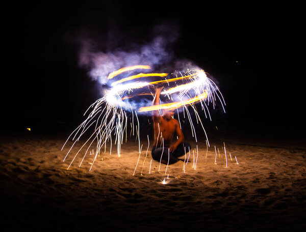 Fire show on the beach at night in Phuket, Thailand