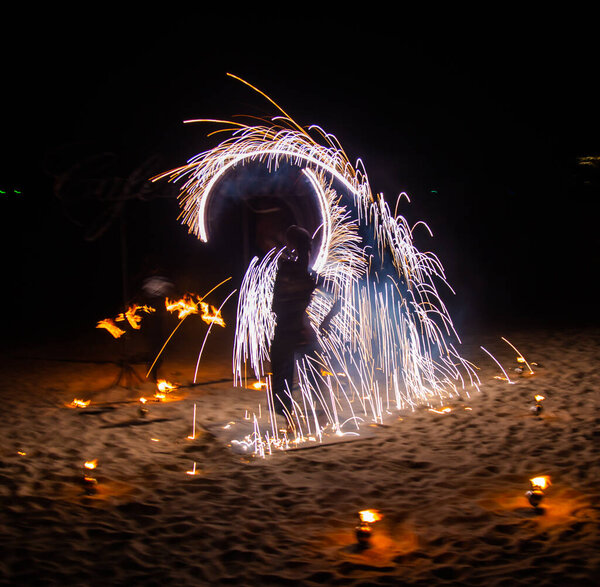 Fire show on the beach at night in Phuket, Thailand