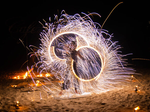 Fire show on the beach at night in Phuket, Thailand