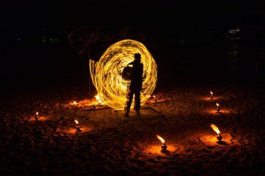 Fire show on the beach at night in Phuket, Thailand