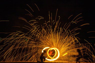 Fire show on the beach at night in Phuket, Thailand