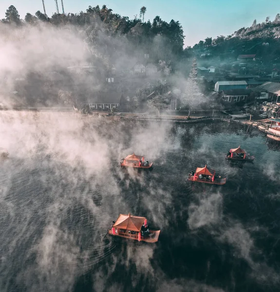 Ban Rak Thai 'de, Tayland' da Mae Hong Son 'da bir göl kenarındaki Çin köyünün üzerinde sisli gündoğumu manzarası.