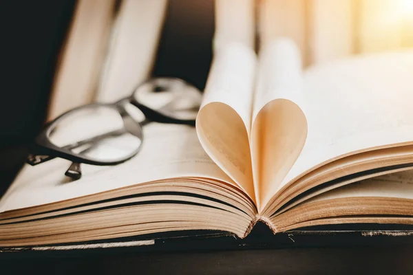 Opened book with heart shaped page. Heart from book page, valentine\'s day