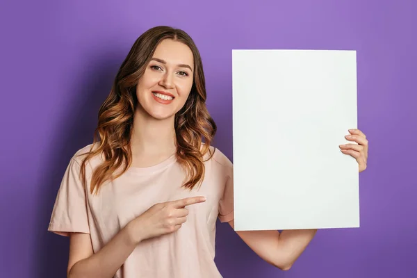 Young Caucasian Student Girl Holding White Sheet Paper Poster Pointing — Stock Photo, Image