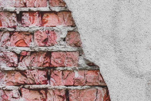 Grunge vintage brick wall texture and white stucco building facade. Brickwork background. White plaster texture, white stucco with red brick