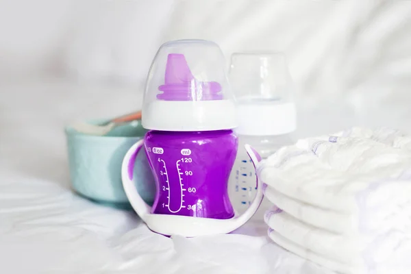Bebé Botella Púrpura Agua Plato Cuchara Juguetes Una Cama Blanca —  Fotos de Stock